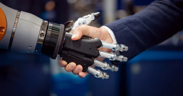 hand-of-a-businessman-shaking-hands-with-a-android-2023-11-27-04-53-03-utc-scaled-1